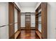 Spacious walk-in closet with custom wood shelving and drawers, providing ample storage and organization at 7733 Pointe Venezia Dr, Orlando, FL 32836