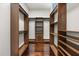 Walk-in closet with custom wood shelving, providing practical storage and closet space at 7733 Pointe Venezia Dr, Orlando, FL 32836