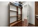 Walk-in closet featuring custom wood shelving, offering plenty of storage, and closet space at 7733 Pointe Venezia Dr, Orlando, FL 32836