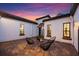 Charming courtyard with brick pavers, stylish seating, and a beautifully designed stucco exterior at 7733 Pointe Venezia Dr, Orlando, FL 32836