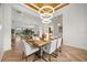 Open-concept dining room with stylish lighting, herringbone floors, and an inviting atmosphere at 7733 Pointe Venezia Dr, Orlando, FL 32836