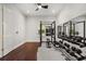 Spacious exercise room features modern workout equipment, wooden floors, and mirrored walls at 7733 Pointe Venezia Dr, Orlando, FL 32836
