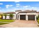 Stunning Mediterranean style home with a two-car garage, lush landscaping, and decorative entry gate creating curb appeal at 7733 Pointe Venezia Dr, Orlando, FL 32836