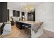 Kitchen with a large island, range, stone backsplash and counters, and modern cabinets at 7733 Pointe Venezia Dr, Orlando, FL 32836