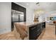 Kitchen featuring a large island with bar seating, stainless steel fridge, and bright lighting at 7733 Pointe Venezia Dr, Orlando, FL 32836