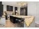 Kitchen featuring a large island with seating, modern appliances and lighting, and dark cabinetry at 7733 Pointe Venezia Dr, Orlando, FL 32836