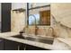 Modern kitchen sink and faucet with marble countertops and stone backsplash at 7733 Pointe Venezia Dr, Orlando, FL 32836