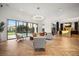 Open concept living room with a view of the pool, stylish seating, and modern finishes at 7733 Pointe Venezia Dr, Orlando, FL 32836