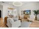 Spacious living room with an open floor plan, stylish furniture, and herringbone wood floors at 7733 Pointe Venezia Dr, Orlando, FL 32836