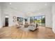 Bright living room with a view of the pool, stylish furniture, and herringbone floors at 7733 Pointe Venezia Dr, Orlando, FL 32836