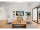 Bright living room with modern furniture, light wood floors, and large windows at 7733 Pointe Venezia Dr, Orlando, FL 32836
