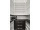 Open pantry with microwave, stone counter, drawers, and white shelves at 7733 Pointe Venezia Dr, Orlando, FL 32836