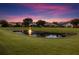 Backyard pond view at dusk in community with a fountain at 7733 Pointe Venezia Dr, Orlando, FL 32836
