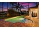 The screened-in pool area is surrounded by lush landscaping and brick pavers at 7733 Pointe Venezia Dr, Orlando, FL 32836