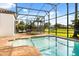 The pool features a screened-in enclosure and brick paver patio with lake view at 7733 Pointe Venezia Dr, Orlando, FL 32836