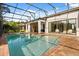 Beautiful screened-in pool with brick pavers and seamless access to the house at 7733 Pointe Venezia Dr, Orlando, FL 32836