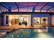 Outdoor pool and patio area with cozy seating, sauna and sliding doors to indoor living spaces at 7733 Pointe Venezia Dr, Orlando, FL 32836