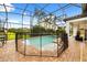 Screened in pool with patio, safety fence, and outdoor seating area offering relaxing outdoor space and sun protection at 7733 Pointe Venezia Dr, Orlando, FL 32836
