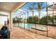 Screened pool and jacuzzi tub with brick patio, safety fence, and outdoor seating providing relaxation and entertainment options at 7733 Pointe Venezia Dr, Orlando, FL 32836