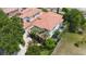 Stunning aerial view of a house with a tile roof, lush landscaping, and a brick driveway at 800 Hamilton Place Ct, Winter Park, FL 32789