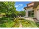 Lush backyard featuring a serene pond, mature landscaping, and cozy seating area at 800 Hamilton Place Ct, Winter Park, FL 32789