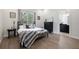Cozy bedroom with a decorative metal bed frame, sleek black dresser, and ensuite bathroom access at 800 Hamilton Place Ct, Winter Park, FL 32789