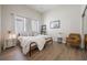 Bright bedroom featuring a metal bed frame, wood-look floors, and a comfortable seating area at 800 Hamilton Place Ct, Winter Park, FL 32789