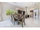 Inviting dining area with modern lighting, elegant chairs, and views of the lush backyard at 800 Hamilton Place Ct, Winter Park, FL 32789