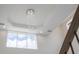 Elegant foyer featuring a stunning chandelier and abundant natural light from a large window at 800 Hamilton Place Ct, Winter Park, FL 32789