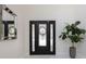 Elegant foyer featuring a decorative glass front door, a large mirror, and a potted plant at 800 Hamilton Place Ct, Winter Park, FL 32789