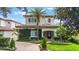 Stunning two-story home with a tile roof, beautiful landscaping, and an inviting brick walkway leading to the front door at 800 Hamilton Place Ct, Winter Park, FL 32789