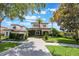 Charming two-story home featuring lush landscaping, a tiled roof, and a paved driveway at 800 Hamilton Place Ct, Winter Park, FL 32789