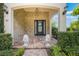 Elegant front porch with stone accents, decorative lion statues, and stylish lighting fixtures at 800 Hamilton Place Ct, Winter Park, FL 32789