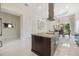 Open kitchen featuring island with cooktop, and breakfast area with outside views at 800 Hamilton Place Ct, Winter Park, FL 32789