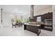 Bright, open kitchen and dining area with modern appliances, granite countertops, and a kitchen island at 800 Hamilton Place Ct, Winter Park, FL 32789