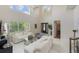 Open living area with bright couches, high ceilings, and a glass coffee table at 800 Hamilton Place Ct, Winter Park, FL 32789