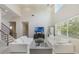 Bright living room featuring soaring ceilings, white sofas, and large windows at 800 Hamilton Place Ct, Winter Park, FL 32789