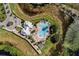 Aerial view showcasing the community pool, clubhouse, and nearby waterway at 8113 Key West Dove St, Winter Garden, FL 34787