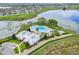 Aerial view of a community pool, clubhouse, and lake at 8113 Key West Dove St, Winter Garden, FL 34787