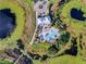 Beautiful aerial view of a pool and clubhouse surrounded by a waterway with mature landscaping at 8113 Key West Dove St, Winter Garden, FL 34787