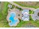 Overhead aerial shot of community pool with large clubhouse, surrounded by tropical landscaping at 8113 Key West Dove St, Winter Garden, FL 34787