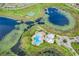 Stunning aerial view of a community pool, clubhouse, tennis courts, and pond with walking trails at 8113 Key West Dove St, Winter Garden, FL 34787