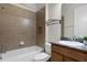 Bright bathroom featuring a shower-tub combo with tile surround and a vanity with granite countertop at 8113 Key West Dove St, Winter Garden, FL 34787