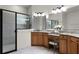Bathroom featuring a double vanity with granite countertops and glass enclosed shower at 8113 Key West Dove St, Winter Garden, FL 34787