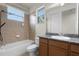 Bright bathroom featuring a shower-tub combo with tile surround and a vanity with granite countertop at 8113 Key West Dove St, Winter Garden, FL 34787