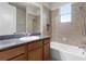 Full bath with a combined shower and bathtub with a light color vanity, granite countertop, and tile surround at 8113 Key West Dove St, Winter Garden, FL 34787