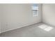Neutral bedroom with carpet, white trim, and natural light from the window at 8113 Key West Dove St, Winter Garden, FL 34787