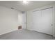 Carpeted bedroom featuring closet and door to the hallway at 8113 Key West Dove St, Winter Garden, FL 34787