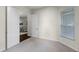 Bright bedroom featuring neutral carpet, a window with blinds, and open doorway to another room at 8113 Key West Dove St, Winter Garden, FL 34787
