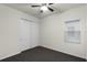 Carpeted bedroom with ceiling fan, closet, and window providing natural light at 8113 Key West Dove St, Winter Garden, FL 34787